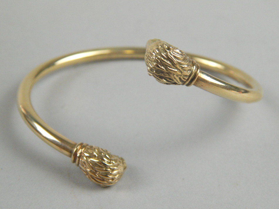 Appraisal: A double lion head hollow bangle yellow metal possibly ct