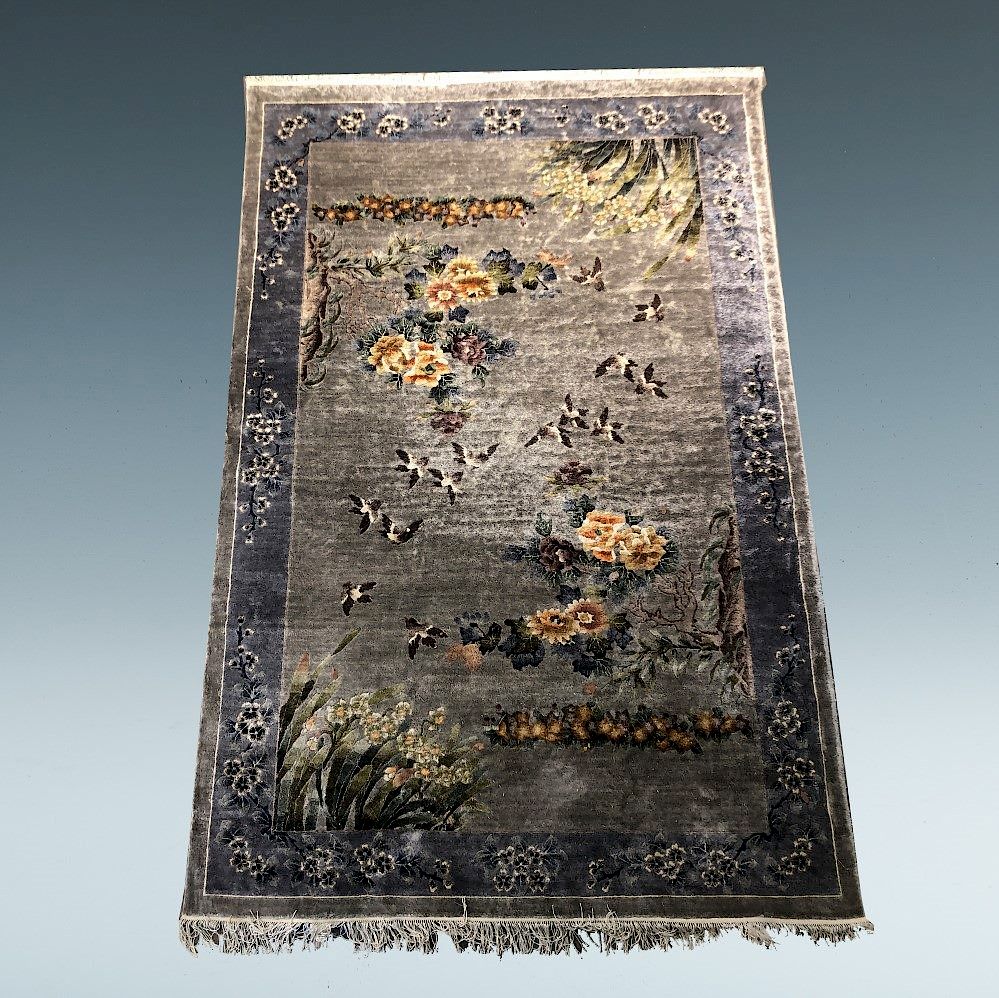 Appraisal: A WOOL RUG A rug depicting birds and flowers on