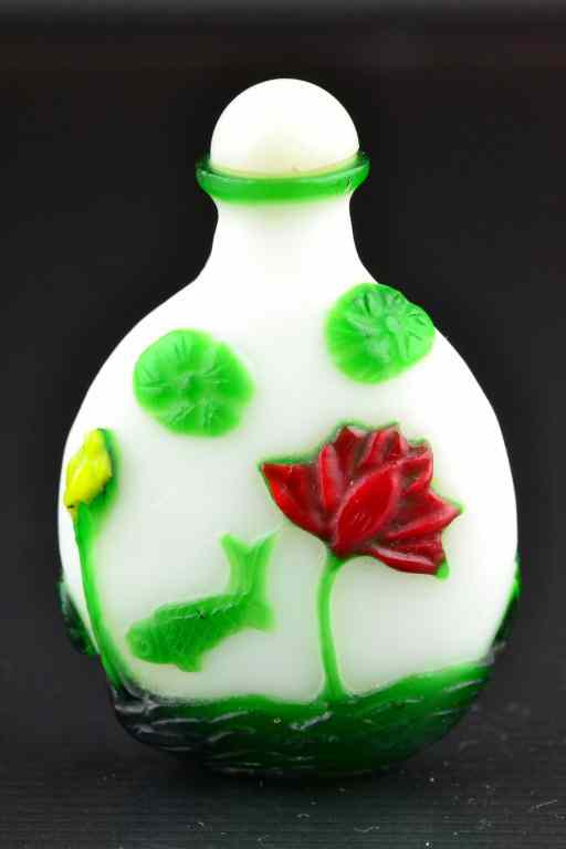 Appraisal: Chinese Peking Glass Snuff BottleFinely molded to depict an underwater