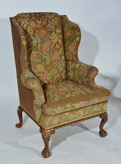 Appraisal: AN TH CENTURY STYLE WING ARMCHAIR covered in polychrome floral