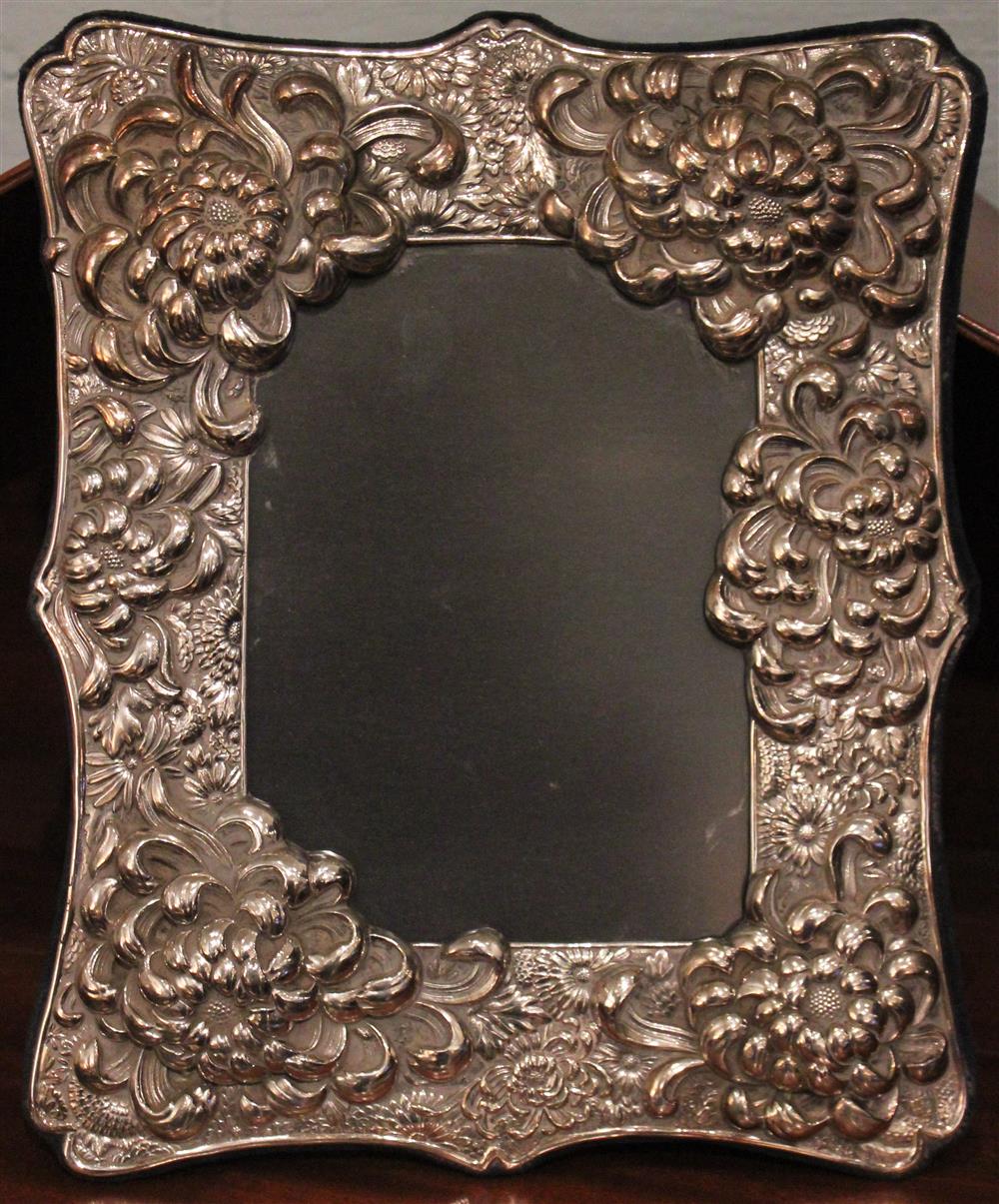 Appraisal: SILVER REPOUSSE FLORAL PICTURE FRAME the shaped rectangular form decorated