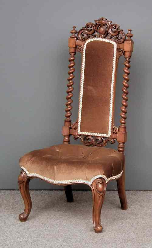 Appraisal: A Victorian walnut high back nursing chair with carved and