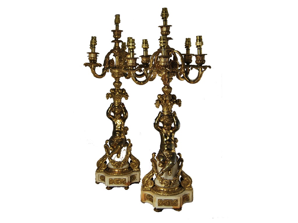 Appraisal: A pair of French ormolu and white marble five-branch candelabrum