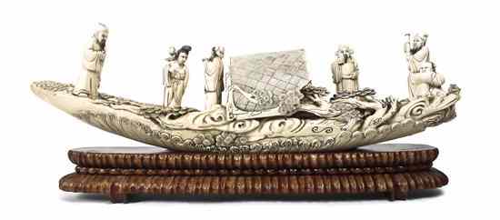 Appraisal: A Chinese Carved Ivory Boat depicted with several figures on