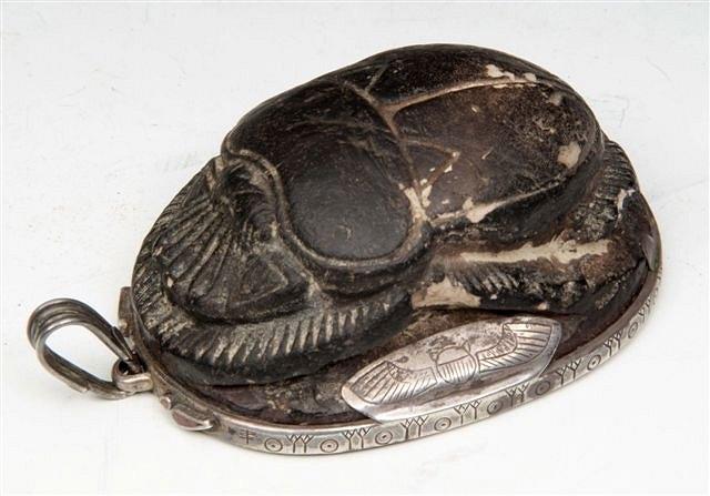 Appraisal: AN EGYPTIAN BLACK FAIENCE HEART SCARAB mounted in Art Deco