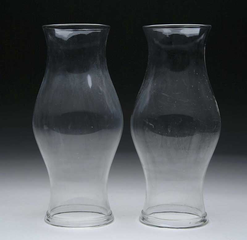 Appraisal: PAIR OF EARLY AMERICAN BLOWN CLEAR GLASS HURRICANE SHADES First