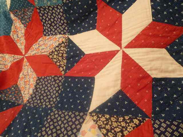 Appraisal: AN ANTIQUE QUILT decorated with red and blue stars '