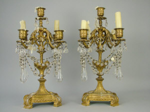 Appraisal: A pair of French gilt bronze candelabra with lustre drops