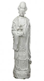 Appraisal: A BLANC-DE-CHINE FIGURE OF GUANYIN AND CHILD Guanyin portrayed wearing