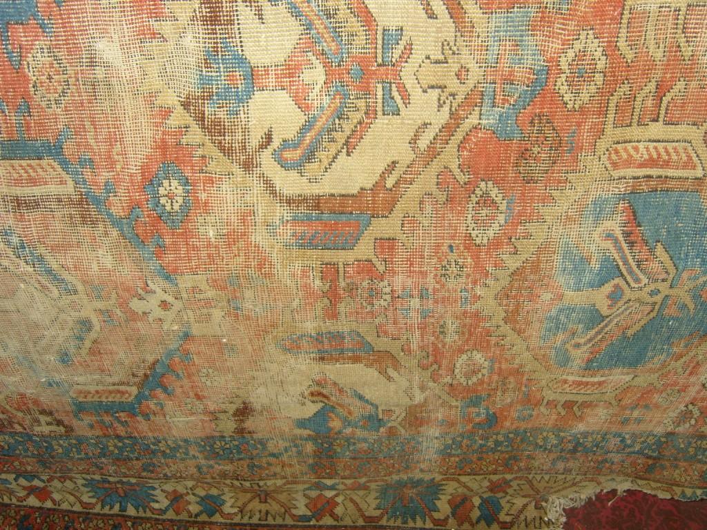 Appraisal: An eastern wool rug with geometric decoration in blue red