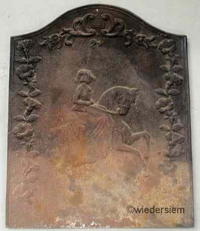 Appraisal: Cast iron fireback with a silhouetted woman riding sidesaddle ''h