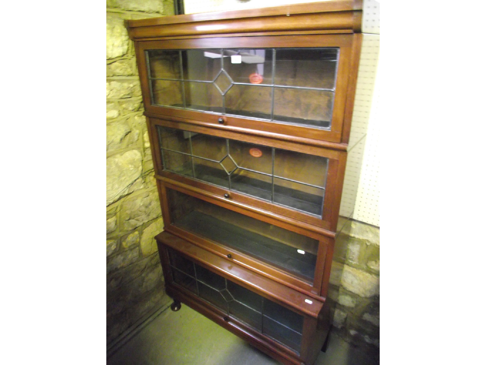 Appraisal: An early th century freestanding four sectional library bookcase graduated