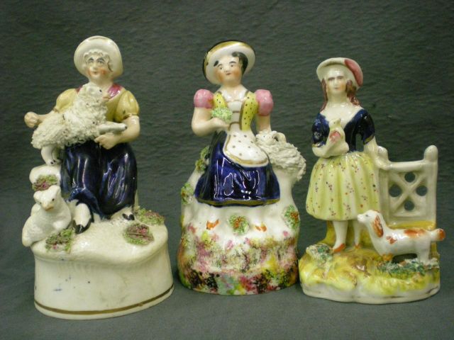 Appraisal: Three Staffordshire figures including figure depicting woman with sheep and