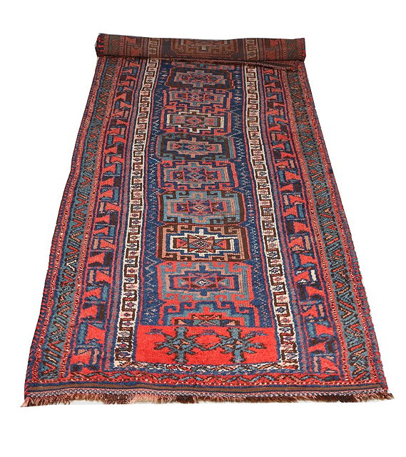 Appraisal: AN EAST TURKISH KURDISH BRICK RED GROUND RUNNER with a