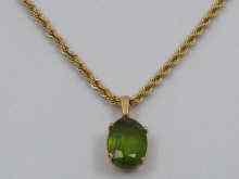 Appraisal: A yellow metal tests ct gold peridot pendant and chain