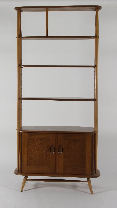 Appraisal: A display cabinet with open shelves above cupboards cm high