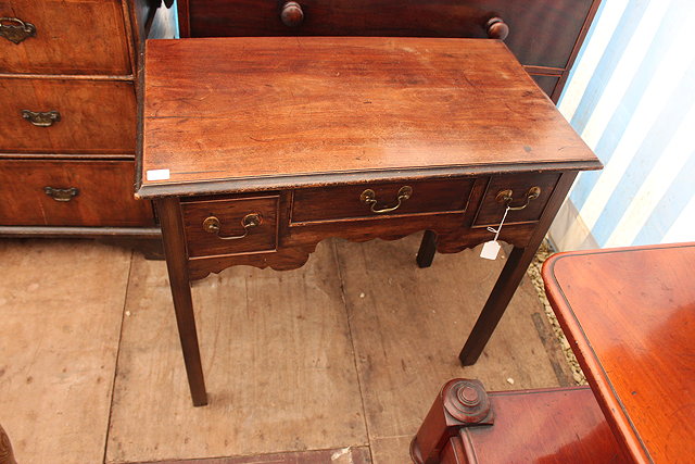 Appraisal: A GEORGE III MAHOGANY LOWBOY the top with a moulded