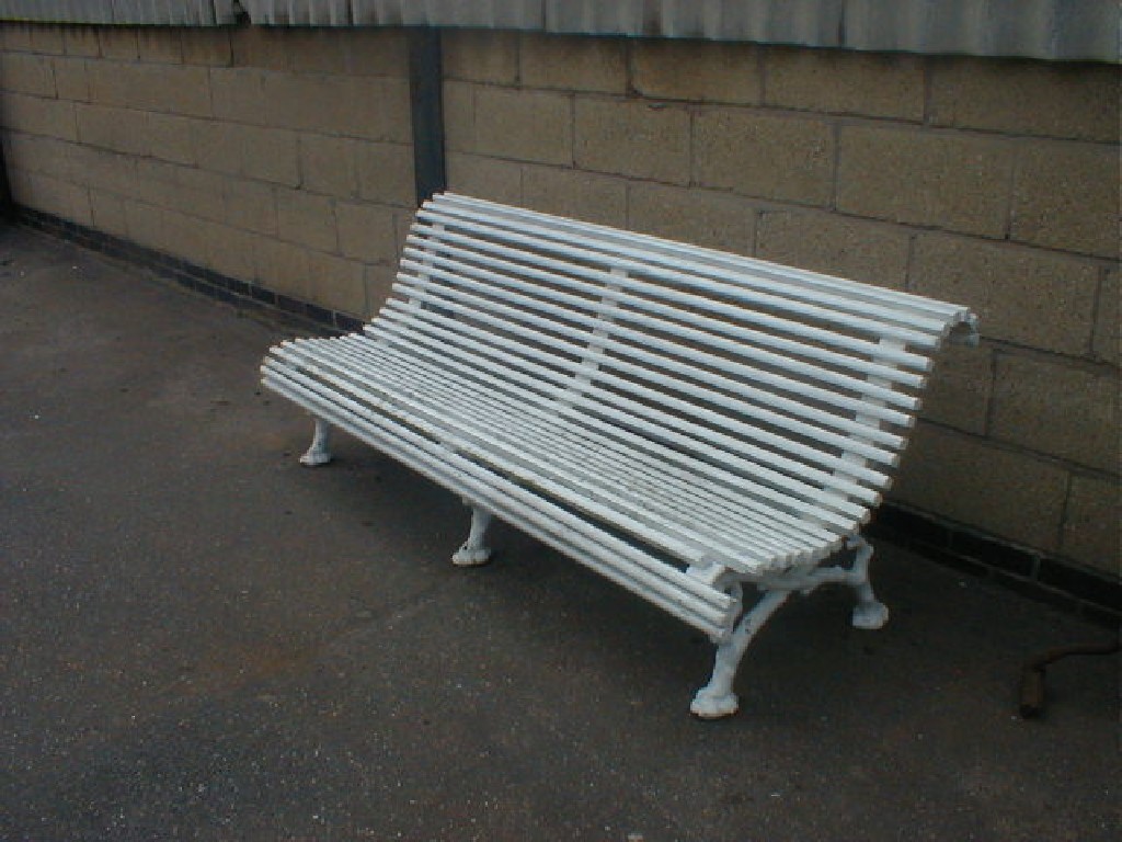 Appraisal: A Victorian garden bench formed with three cast scrolling supports