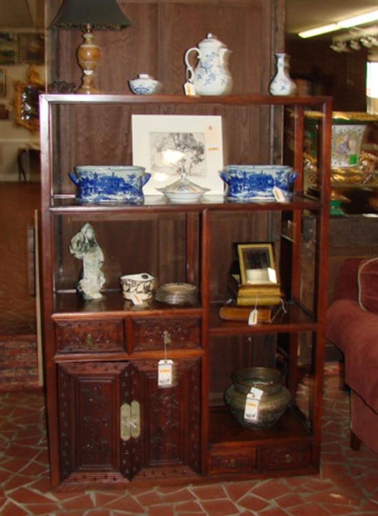 Appraisal: Chinese carved hardwood open curio cabinet circa rectangular form divided