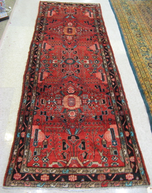 Appraisal: PERSIAN TRIBAL HALL CARPET overall stylized floral design on red