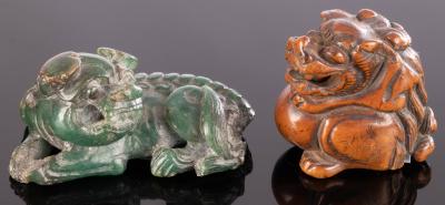 Appraisal: A Japanese carved green jade recumbent Fu dog and pup