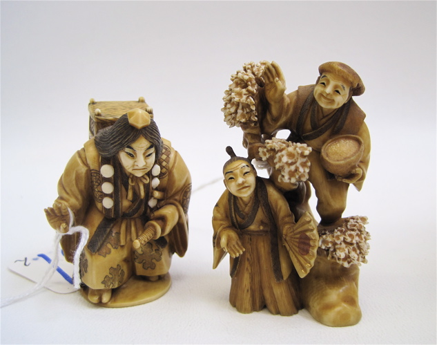 Appraisal: TWO SIGNED JAPANESE CARVED IVORIES a man carrying a wooden