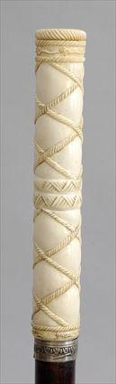 Appraisal: IVORY-HANDLED WOOD WALKING STICK Carved with rope lattice beneath twist-off