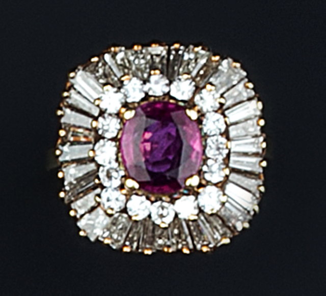 Appraisal: A RUBY AND DIAMOND CLUSTER RING the oval mixed-cut ruby