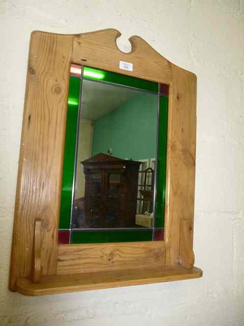 Appraisal: A PINE FRAMED WALL MIRROR with green and red leaded