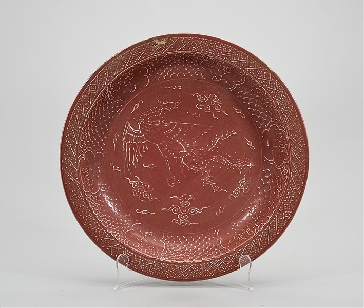 Appraisal: Chinese red glazed porcelain charger low relief design dragon chasing