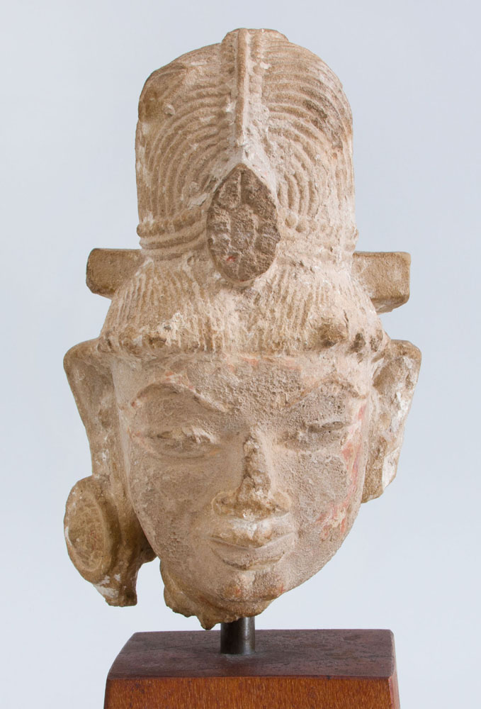 Appraisal: WESTERN INDIAN CARVED BUFF SANDSTONE HEAD OF A DEITY x