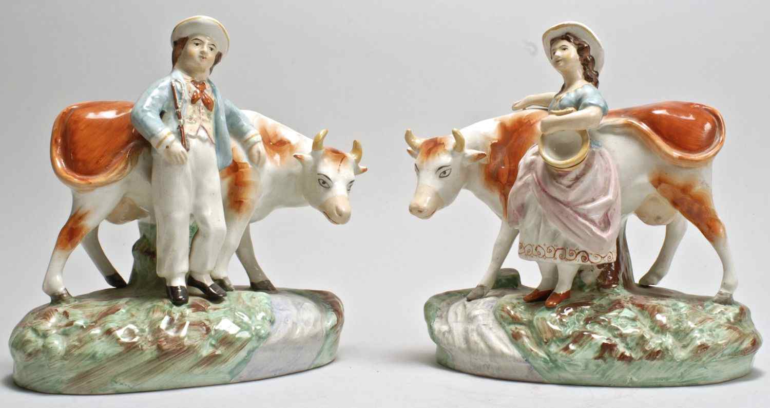 Appraisal: PAIR OF STAFFORDSHIRE FIGURE GROUPS th CenturyOne of a boy