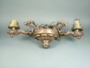 Appraisal: An Empire style bronzed twin branch chandelier with hanging chains