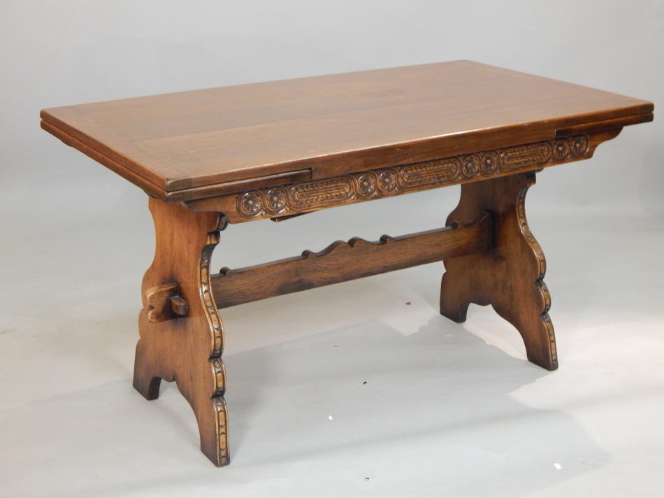 Appraisal: A Titchmarsh Goodwin oak draw leaf table with a flower