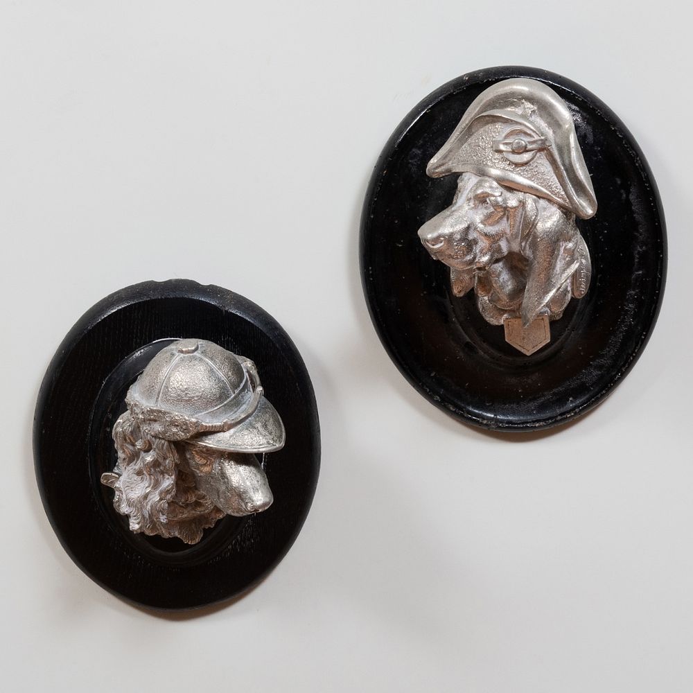 Appraisal: Pair of Cast Metal Dog Heads in Jaunty Hats On