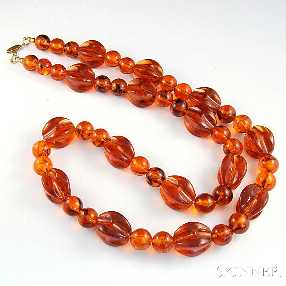 Appraisal: Long Amber Bead Necklace composed of alternating pinched and round