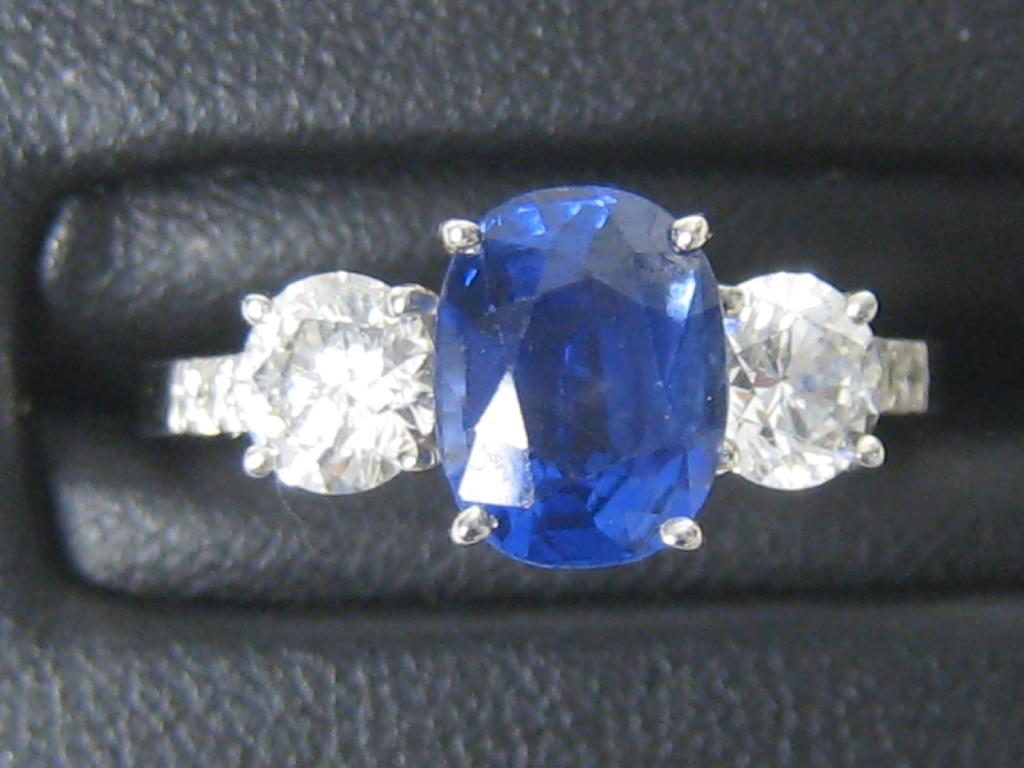 Appraisal: A Sapphire and Diamond three stone Ring claw-set central oval-cut