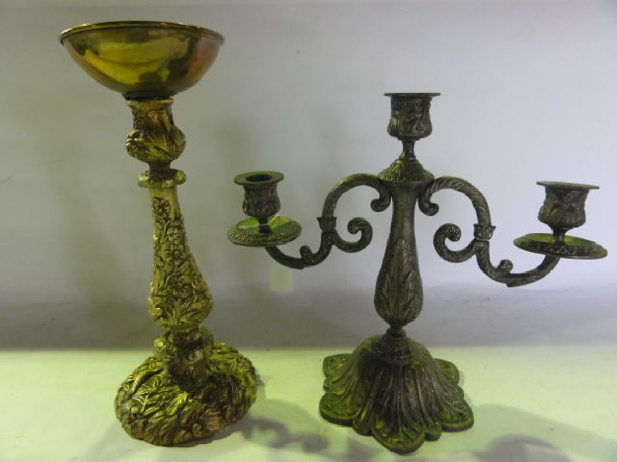 Appraisal: An ormolu style candle stand with embossed detail of birds