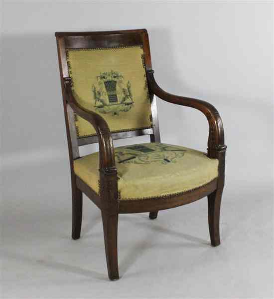 Appraisal: A carved mahogany Empire style elbow chair on sabre legs