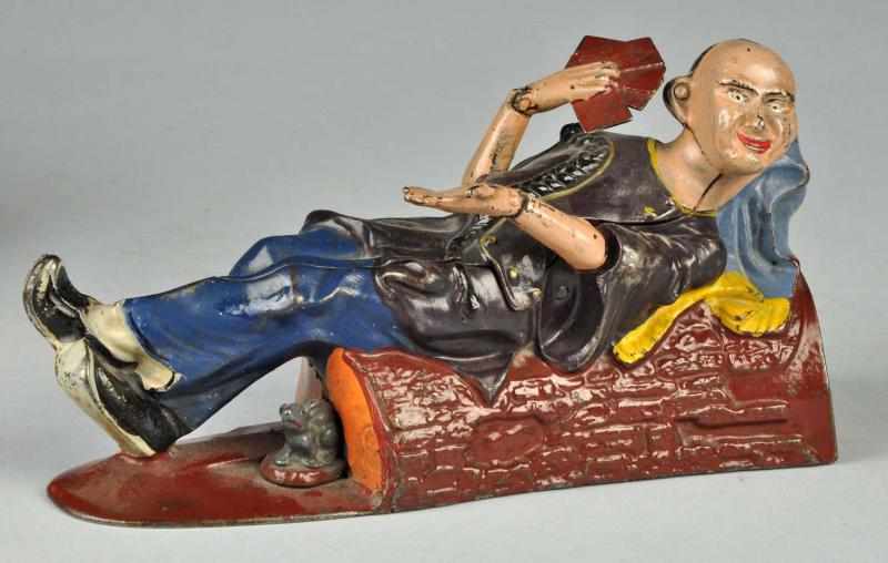 Appraisal: Cast Iron Reclining Chinaman Mechanical Bank Description Working Manufactured by