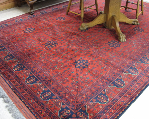 Appraisal: AFGHANI TRIBAL CARPET hand knotted in a multiple rosette medallion