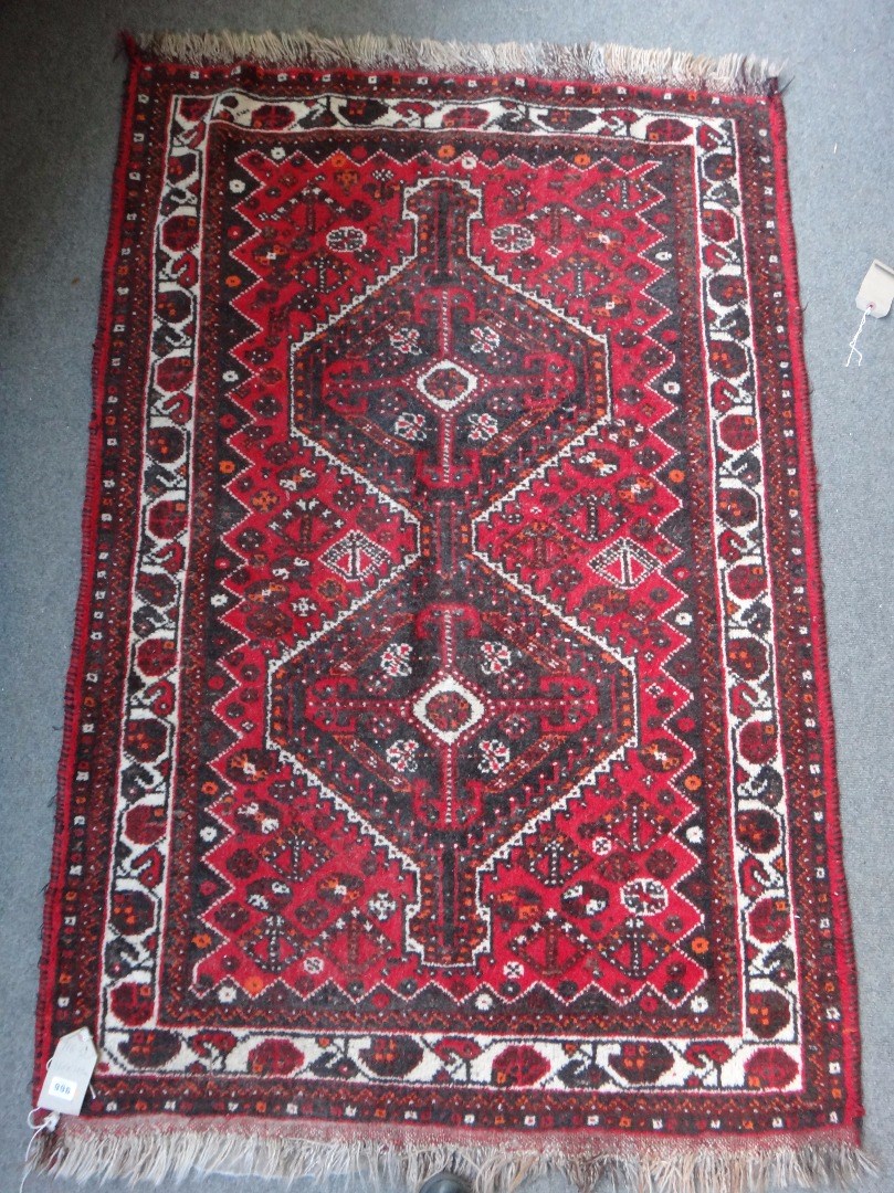 Appraisal: A Shiraz rug South Persian the madder field with a