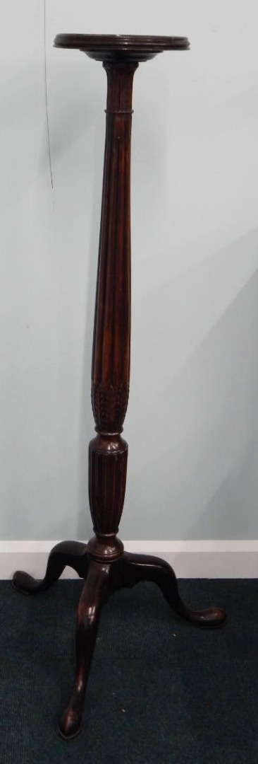 Appraisal: A mahogany torchere the circular galleried top readed and leaf