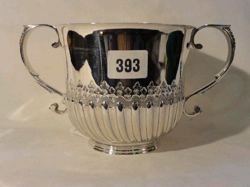 Appraisal: A Georgian style open silver two handled cup with shaped