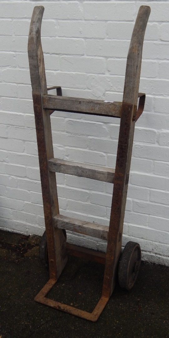 Appraisal: A bygone wooden sack barrow with metal mounts on two