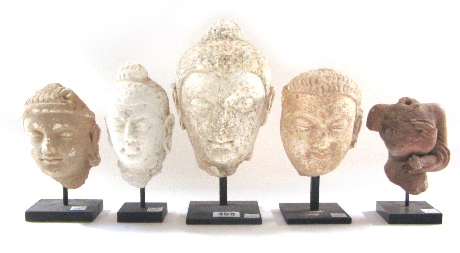 Appraisal: Four stucco heads of Buddha probably Gandharan th century largest