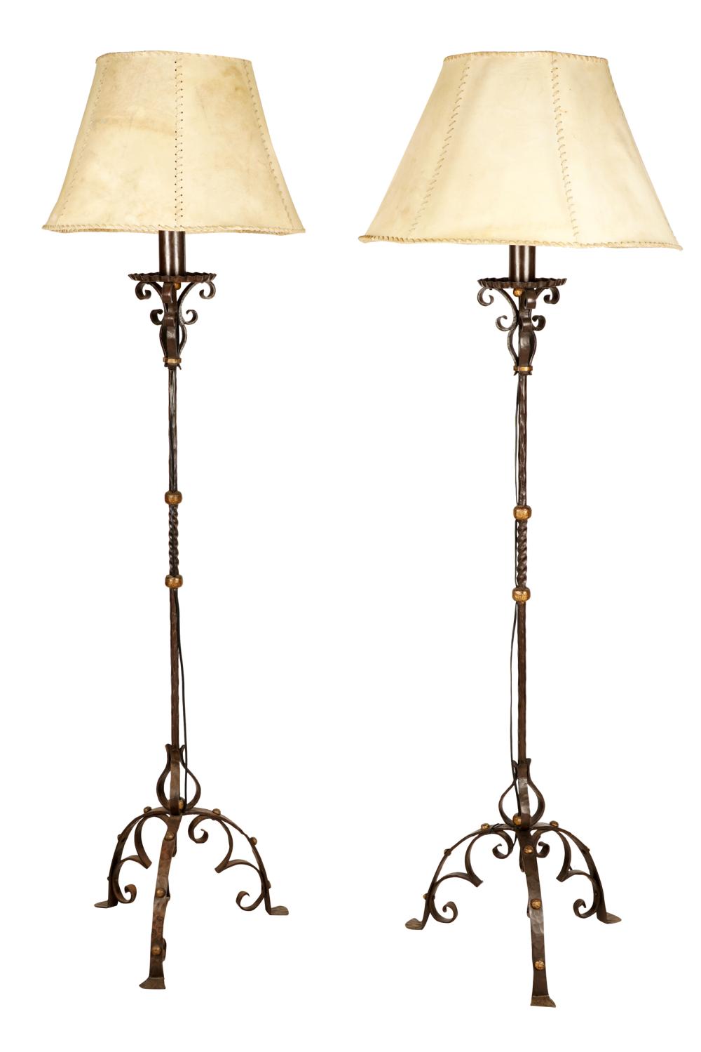 Appraisal: PAIR OF WROUGHT IRON FLOOR LAMPSeach with a hide shade