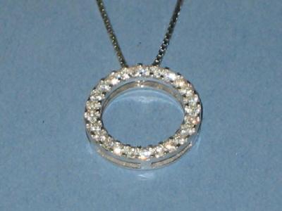 Appraisal: A DIAMOND PENDANT modelled as a circle of brilliant cut