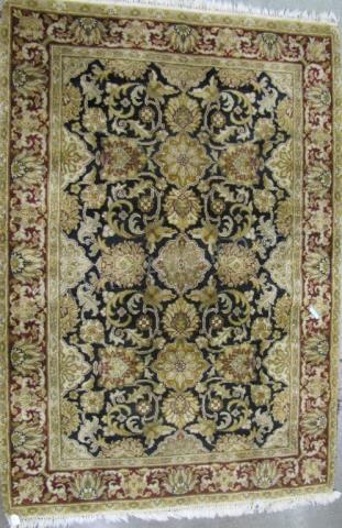 Appraisal: A handmade Oriental area rug black field with gold traditional