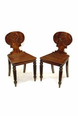 Appraisal: A pair of George IV mahogany hall chairs in the